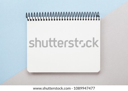 Minimal composition with clean notebook on geometric pastel background top view. Flat lay style.