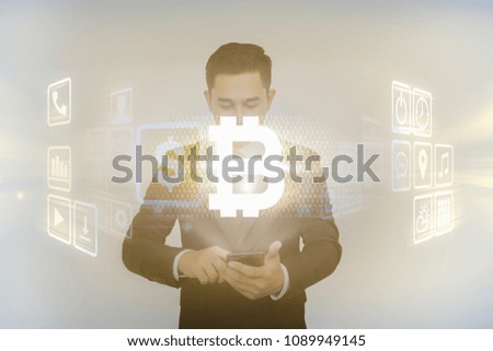 Abstract Image of Businessman touch smartphone to use the Bitcoin and digital hologram. Future Business Bitcoin and technology Concept.