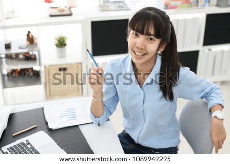 Young employee working on her desk with laptop