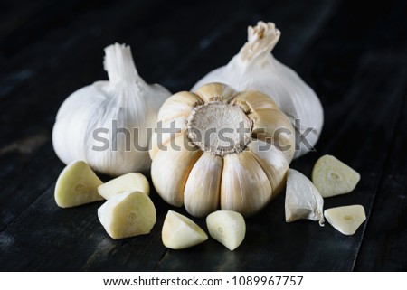 Close up garlic on black wood 