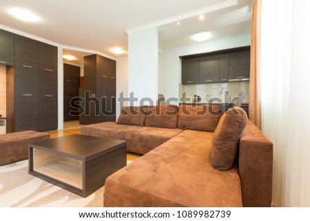 Interior of a modern open plan hotel apartment, living room