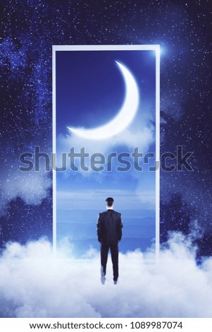 Back view of young businessman standing on abstract cloud sky background. Dream and imagination concept