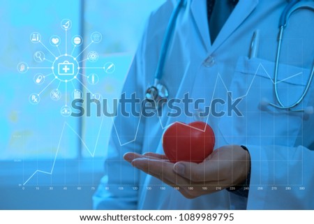 doctor holding red heart shape in hand with medical ,technology,science icon network connection modern virtual line and dots screen interface Structure communication. Big Data Visualization.