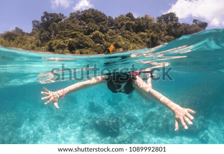 the woman snorkel  above coral reef