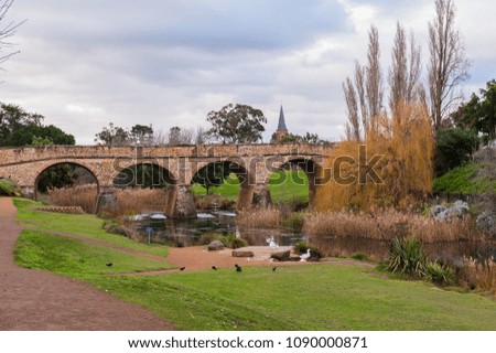 old stone bridge in rural hobart tasmania with ducks and stream