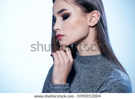 beautiful woman with dark hair on a light background                        