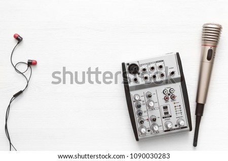 Audio recording studio desk table. Karaoke mock up. Song lyrics. Microphone, sound mixer and headphones on white wooden table background with copy space.