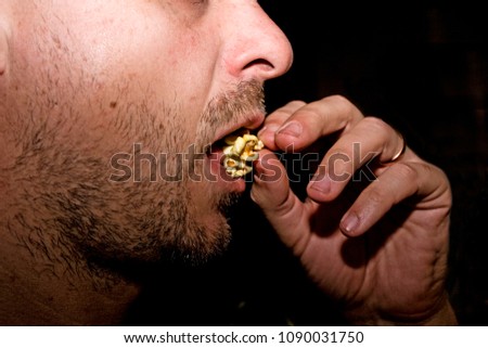 profile of a man eating popcorn
