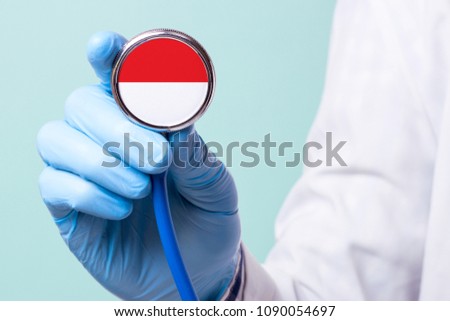 Medicine in Indonesia is free and paid. Expensive medical insurance. Treatment of disease at the highest level Doctor holding a stethoscope in his hand