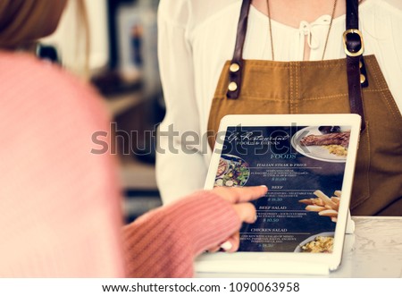 Customer ordering food at restaurant counter Royalty-Free Stock Photo #1090063958
