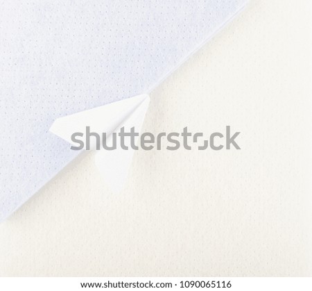 White Paper Plane or Paper Airplane Origami on Pastel Blue Background Top View with Place for Text