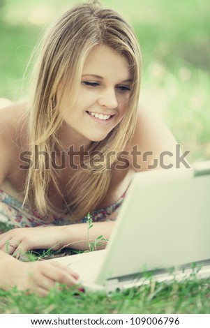 Girl with laptop at outdoor.