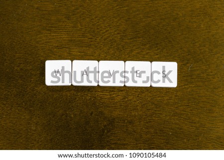 WAVES word written on plastic keyboard alphabet with dark background