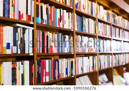Different books on shelves in library
