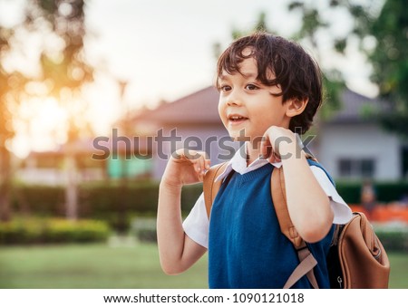 A little boy go to school in semester start day. Royalty-Free Stock Photo #1090121018