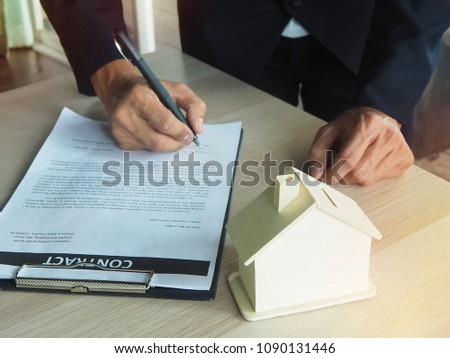 Man hand is holding a pen in the name of the contract. Acceptance of contract terms concept