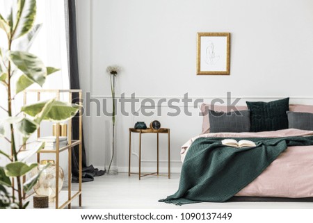 White wall with molding in glamor bedroom interior with dirty pink bedding on the bed