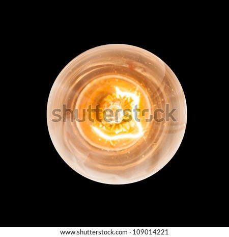 Light bulb illuminated and taken from above and isolated against black Royalty-Free Stock Photo #109014221