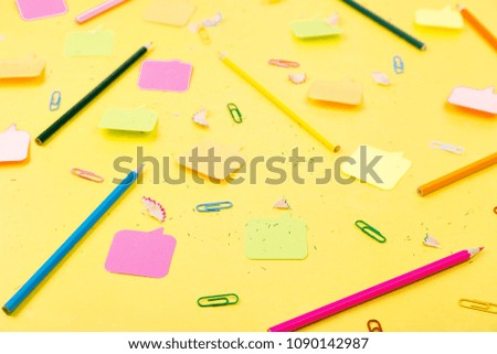 Search idea concept. Colorful pencils, stickers, clips on yellow background.  School supplies.  Exam, school student
