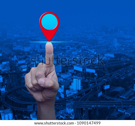 Businessman pressing map pin location button over modern city tower, street and expressway, Map pointer navigation concept