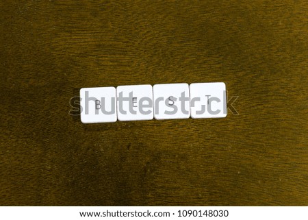 BEST word written on plastic keyboard alphabet with dark background