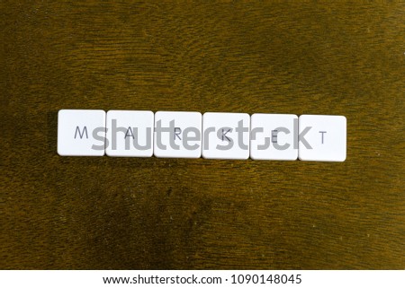 MARKET word written on plastic keyboard alphabet with dark background