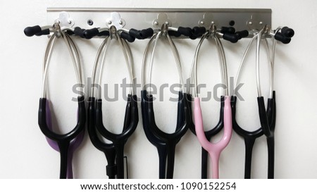 Stethoscopes hangs on white wall.only earphone.