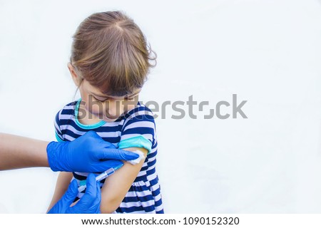 vaccination of children. An injection. Selective focus. Royalty-Free Stock Photo #1090152320
