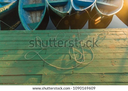 Pier/dock wooden floor background texture with boats and sunset 