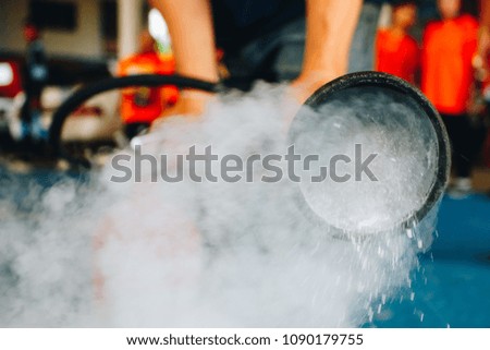 Use a fire extinguisher to fire at the gas tank.