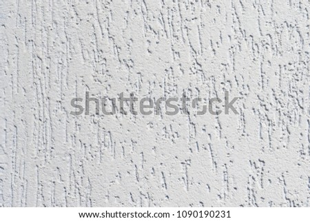 Plastered surface of a wall with furrows of light blue color