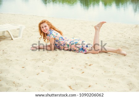 Smiling positive young woman in summer dress moving ,dancing and smiling on the beach, vintage style, rest on a river or lake