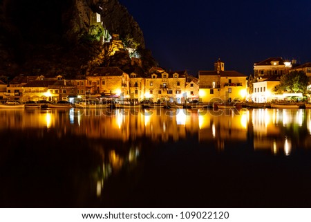 Illuminated Pirate Castle and Town of Omis Reflecting in the Cetina River at Night, Croatia