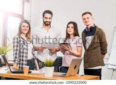 Team of office workers before flip chart board, indoor shot in modern office