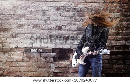 Beautiful young girl rocker with electric guitar. 