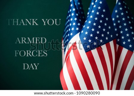 some american flags and the text thank you and armed forces day against a dark green background Royalty-Free Stock Photo #1090280090