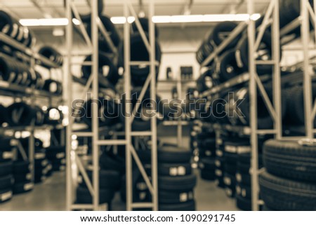 Vintage blurred rows of brand new tires for sale at auto care center retail store in USA. Defocused background of industrial repair services