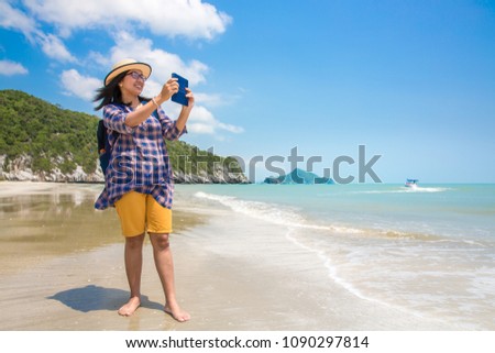 Tourist taking photo on the beach, Vacation concept