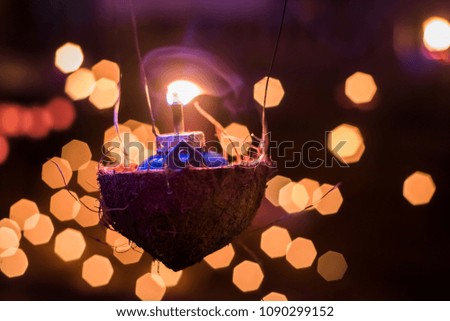 A traditional kerosene lamp  also known as pelita with light bokeh as background. Eidul fitri concept. Image contains grain and soft focus.