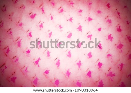 A fence texture in the snow. Metal grill in frost. Pink toning. Abstract background.