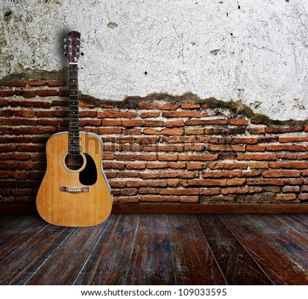 Guitar in grunge room.