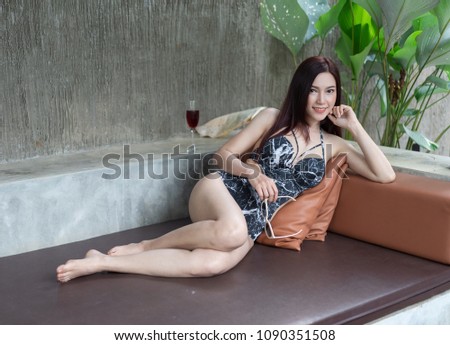 young woman resting on a chair in swimming pool