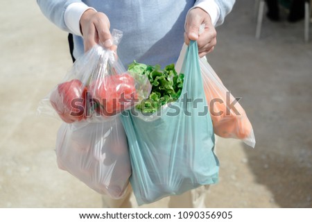 Close up on person buyer hold groceries in bags. Buy sell vegetables. Healthy wellbeing lifestyle background Royalty-Free Stock Photo #1090356905