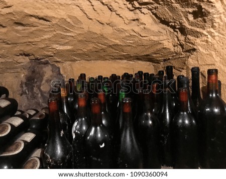Bottles of wine at rest in a cave of a cellar