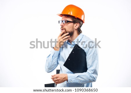 bearded man in a helmet and with a folder                               