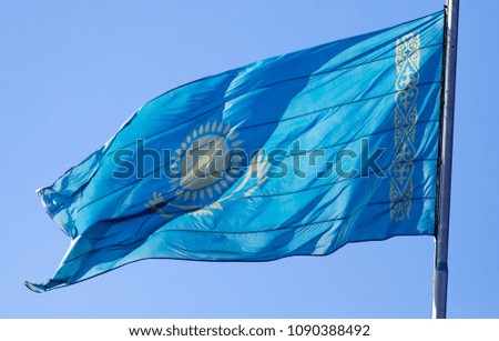 Flag of Kazakhstan against the blue sky