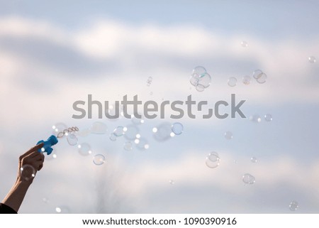 Soap bubbles in flight against the sky