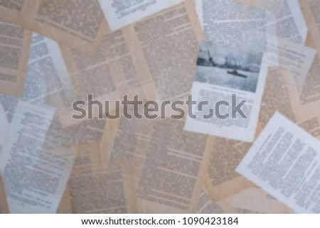 Old pages of the book are spread out and pasted over Blured photo