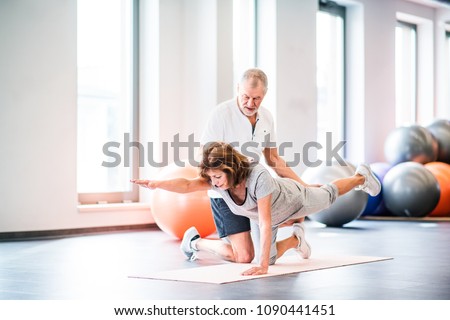 Senior physiotherapist working with a female patient. Royalty-Free Stock Photo #1090441451