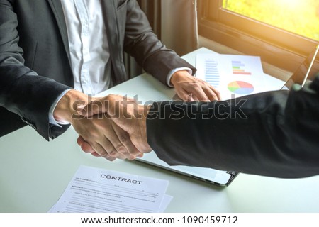 Business man shaking hands for contract and financial graphic 